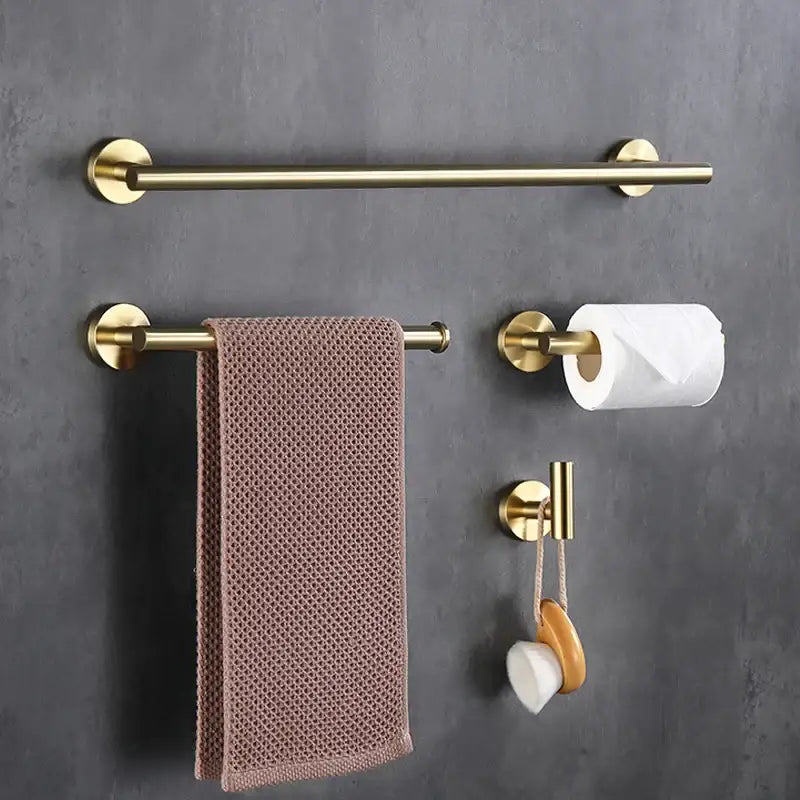 Brass bathroom towel rack with circular end caps and textured mauve towel in decorbites brushed gold bathroom set