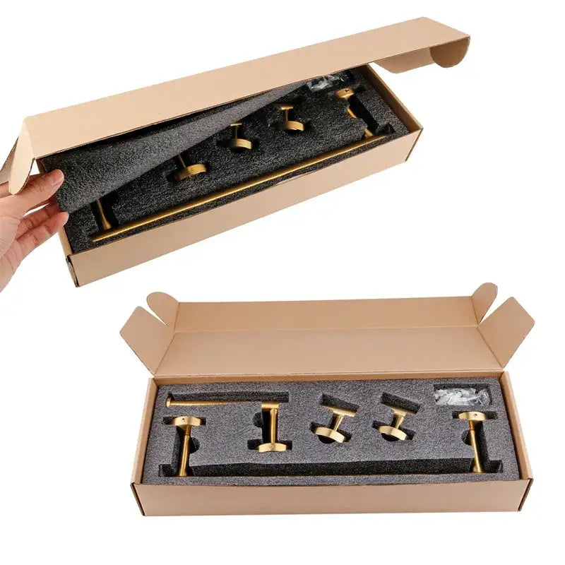 Brushed gold bathroom hardware set with towel bar and robe hooks in a sleek box with black foam lining