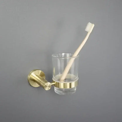 Brushed gold bathroom pendant wall-mounted toothbrush holder with clear glass cup and brass accents by decorbites