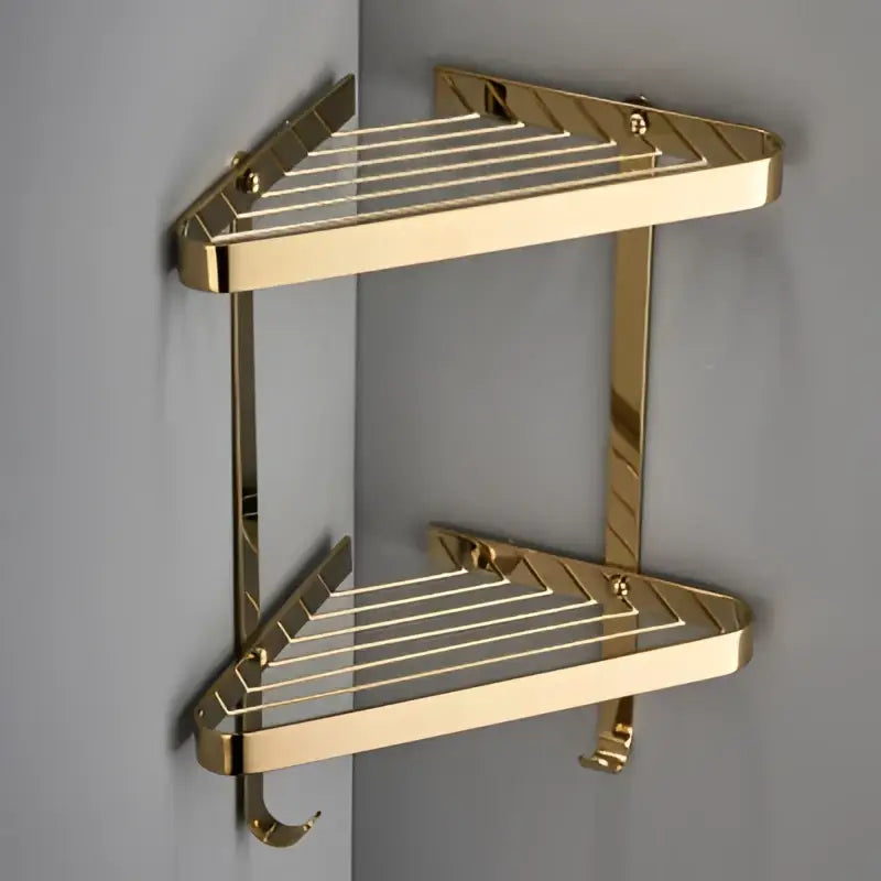 Gold-colored double-tiered brushed brass bathroom shower rack with diagonal slat design for corner decorbites brass bathroom storage