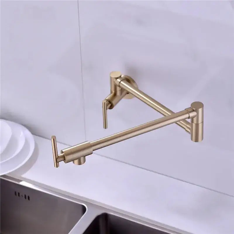 Brushed gold foldable pot filler faucet with extendable arm in brushed metal finish for kitchen wall mount use