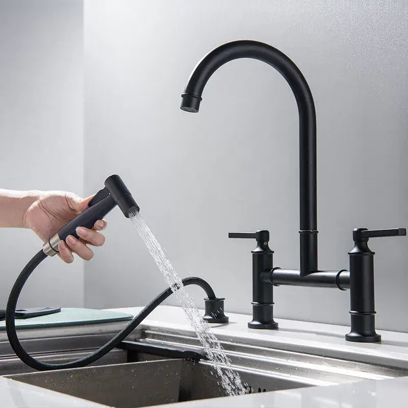 Black matte kitchen faucet with curved spout two handles and hand shower head attached on flexible hose