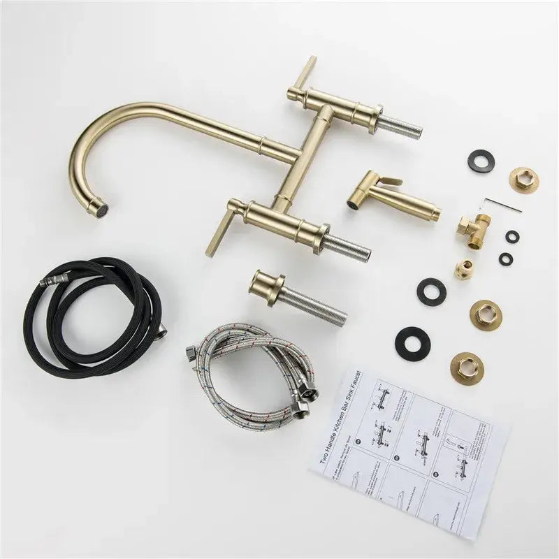 Brushed gold kitchen bridge faucet with hand shower head and brass-finished two-handle kit including flexible hoses