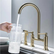 Brushed gold kitchen bridge faucet with hand shower head and high-arc spout in brass finish for versatile use