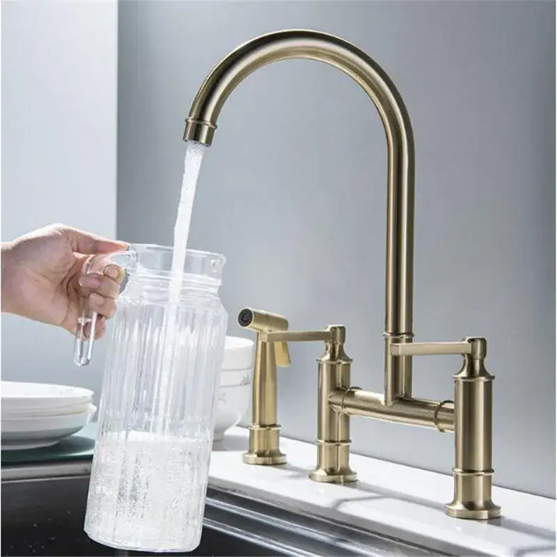 Brushed gold kitchen bridge faucet with hand shower head and high-arc spout in brass finish for versatile use