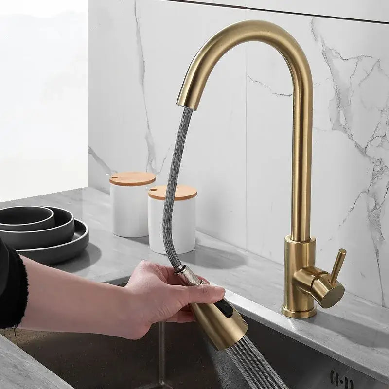 Brushed gold kitchen faucet with pull down spray head featuring a brass-finished flexible hose and sleek curved spout decorbites brushed gold