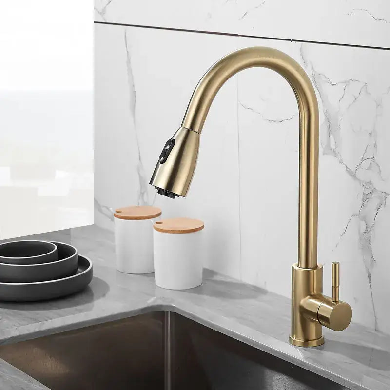 Brushed gold kitchen faucet with pull down spray head and sleek curved spout by decorbites for modern kitchens