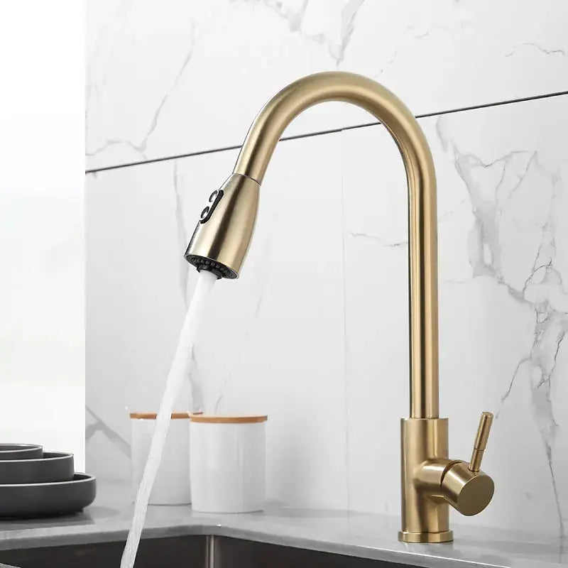 Brushed gold kitchen faucet with a sleek curved spout and pull down spray head by decorbites