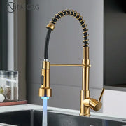 Brushed gold led kitchen faucet with black spring pull down hose and blue led lighting at the spout decorbites brushed gold