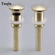 Two brushed gold pop-up drain stoppers with cylindrical design and white rubber gaskets for bathroom sinks