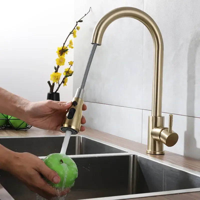 Brass-finished kitchen faucet with sleek arched spout and pull-down spray in decorbites brushed gold textured hose design