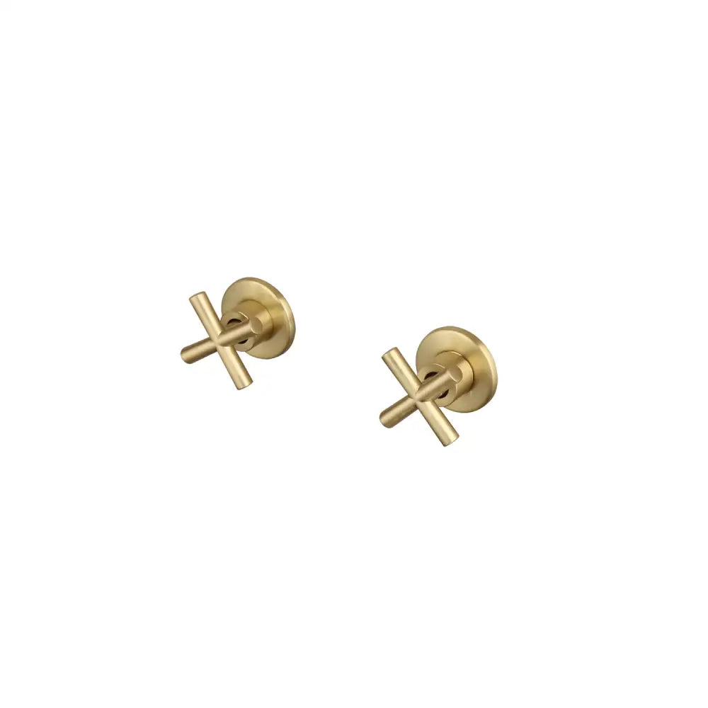 Gold-tone cross-shaped stud earrings with minimalist design paired with brushed gold square rainfall shower faucet set bathroom with cross handles