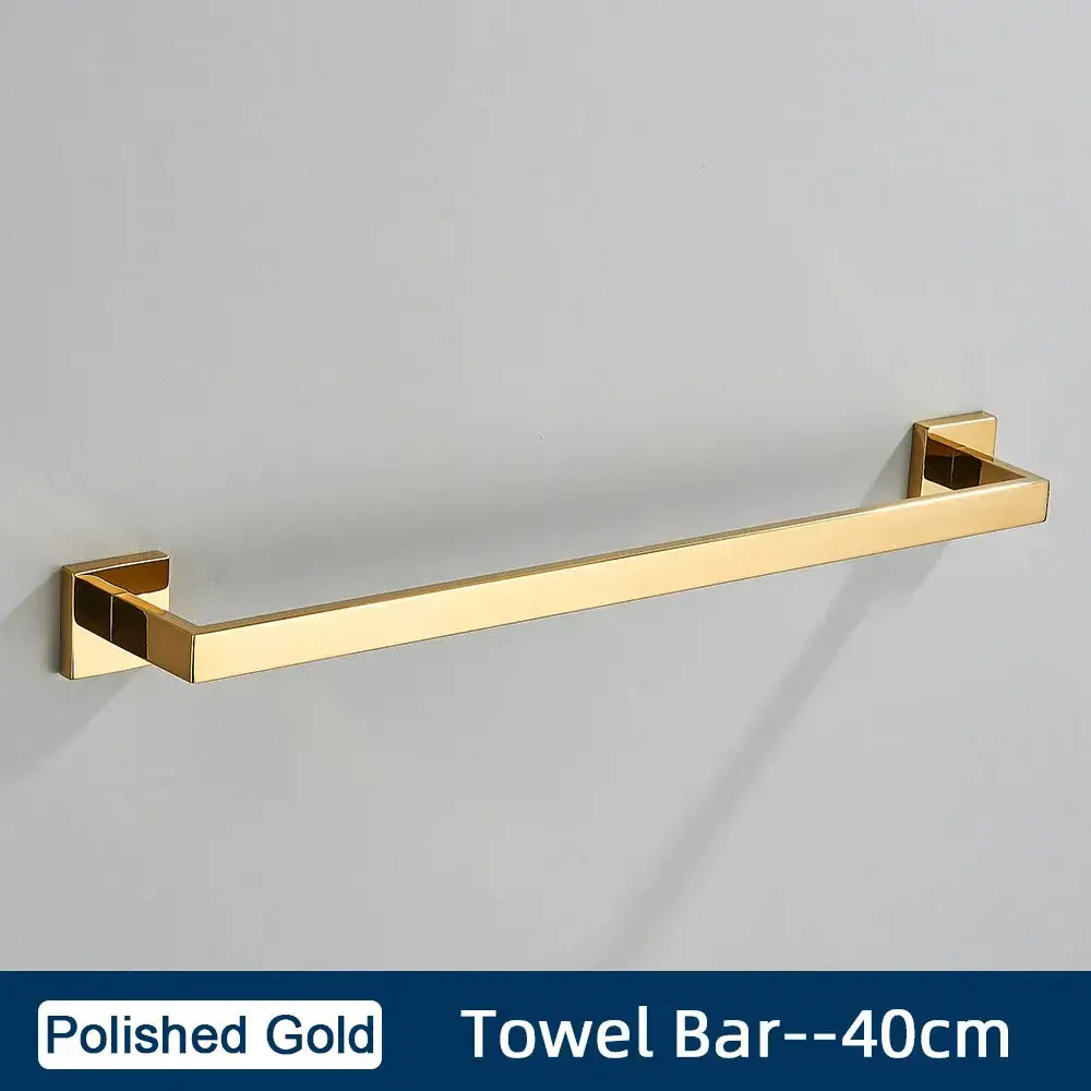 Polished gold towel bar with sleek rectangular design and square brackets in brushed gold stainless steel bathroom accessories set