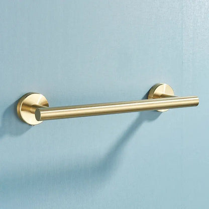 Brushed gold stainless steel towel rack with sleek cylindrical design in a bathroom accessories set