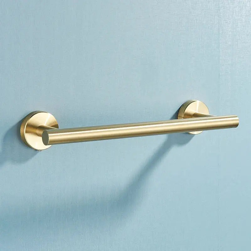 Brushed gold stainless steel towel rack with sleek cylindrical design in a bathroom accessories set