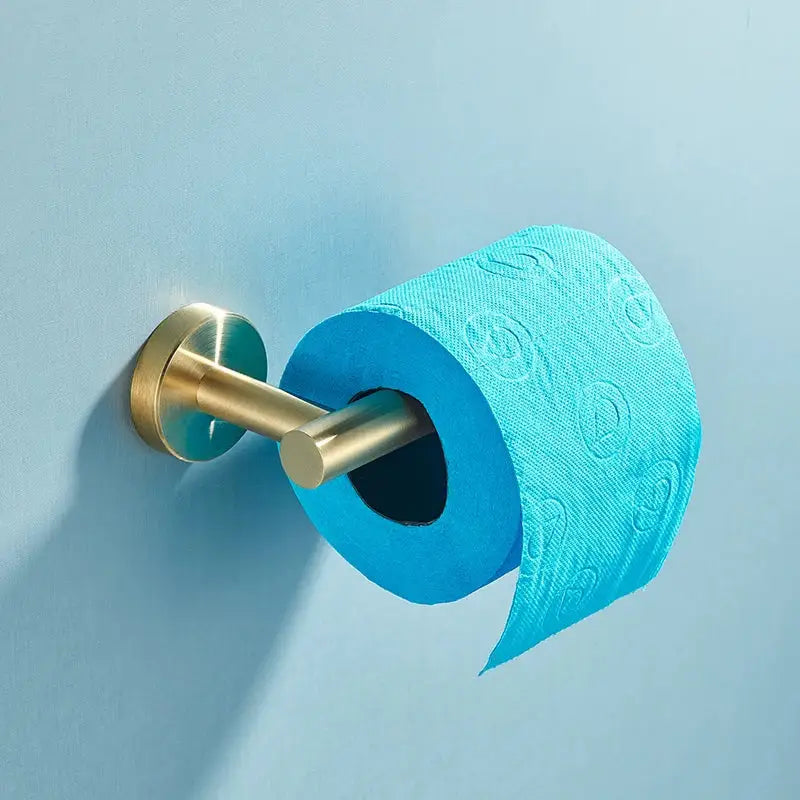 A vibrant blue toilet paper roll with embossed pattern on brushed gold stainless steel bathroom accessories set holder