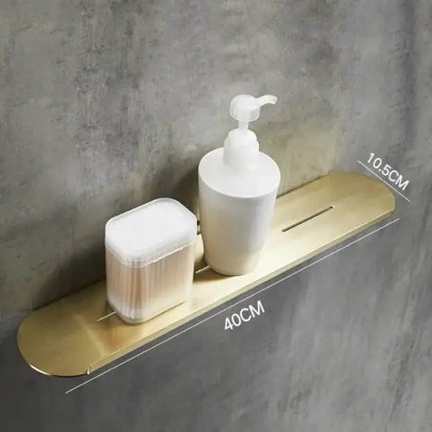 Brushed gold stainless steel bathroom storage rack with mirror front holding white pump bottle and cotton swabs