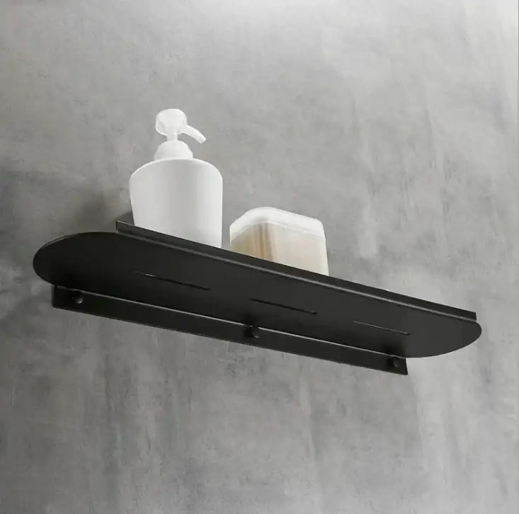 Black metal wall-mounted bathroom storage rack with sleek modern design and subtle horizontal grooves for bathroom storage