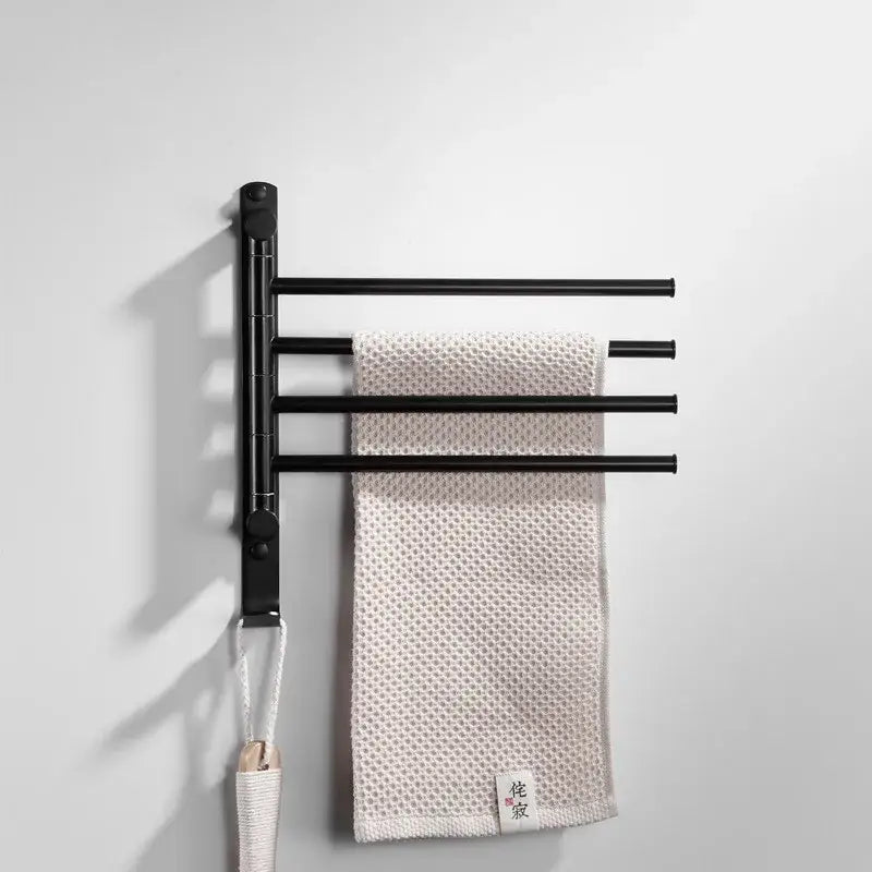Black metal wall-mounted towel hanger with four extendable bars holding beige towel from decorbites brushed gold rack