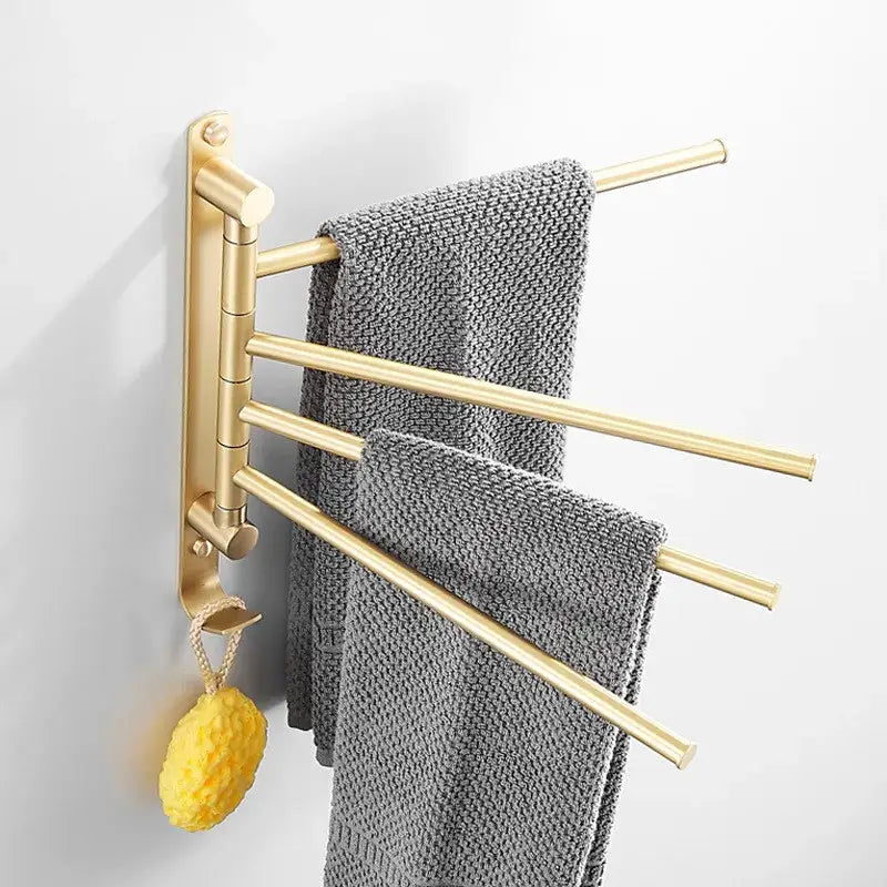 Brushed gold towel hanger with three extendable swivel arms holding gray towels for bathroom use by decorbites brushed gold