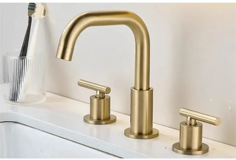 Modern brushed gold basin faucet with three handles and a sleek waterfall design for bathroom sinks decorbites brushed gold