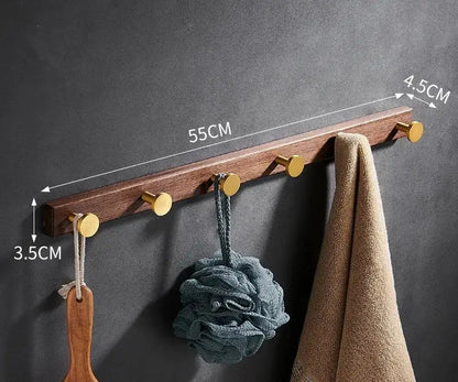 Brushed gold wood and aluminum robe hook towel hanger with five gold-toned hooks in natural wood finish