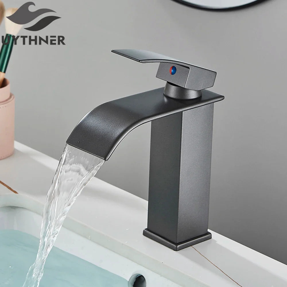 Matte black single hole basin faucet with sleek waterfall design and blue red temperature indicator for bathroom sink