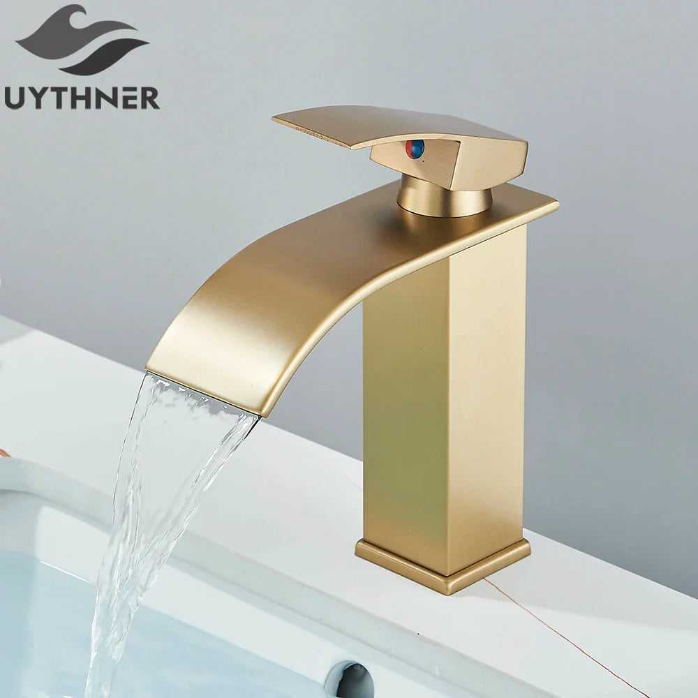 Brushed golden basin faucet with a single hole deck mount and sleek waterfall spout in modern brass mixer taps design