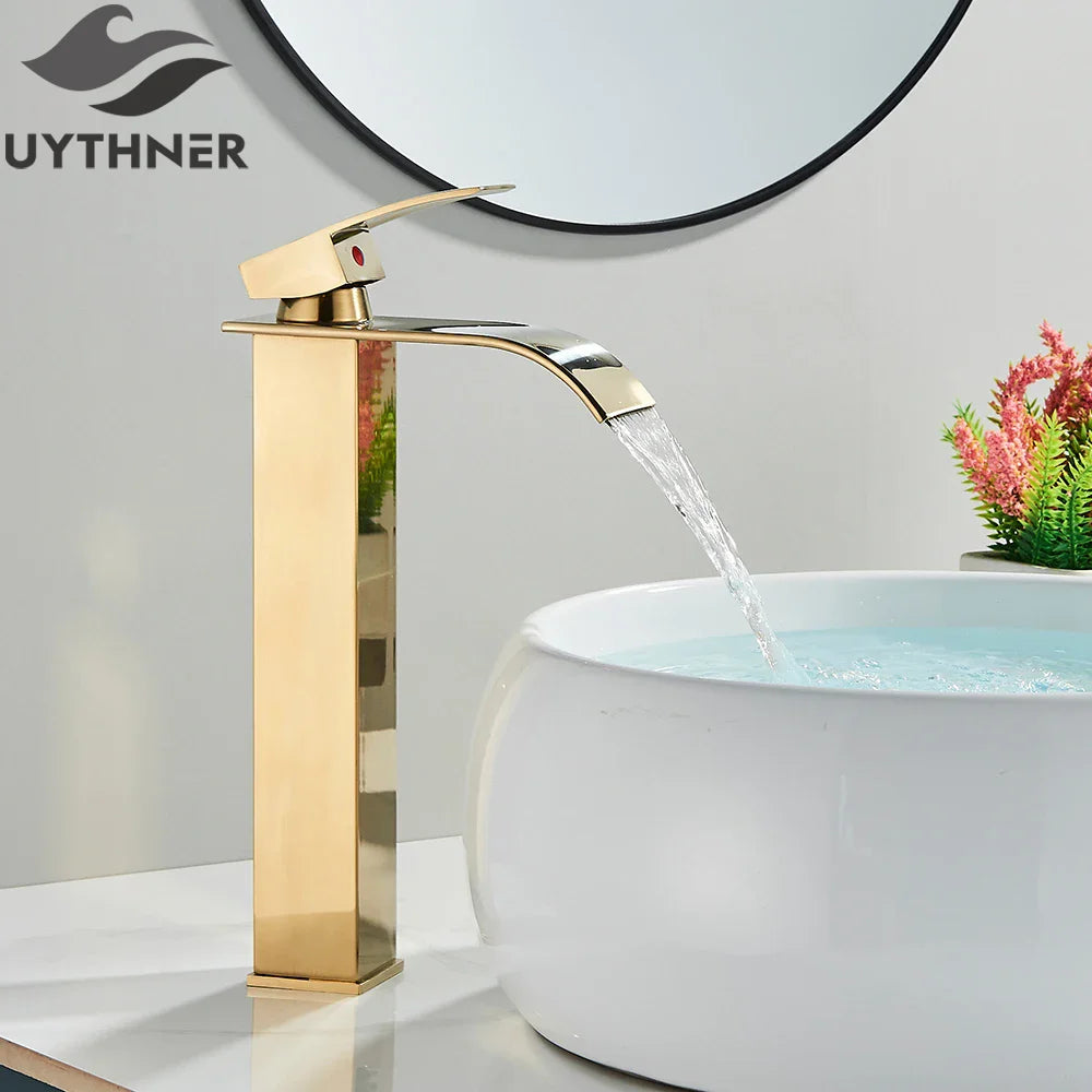 Brushed golden single hole basin faucet with elegant waterfall design and red accent button for bathroom sink use