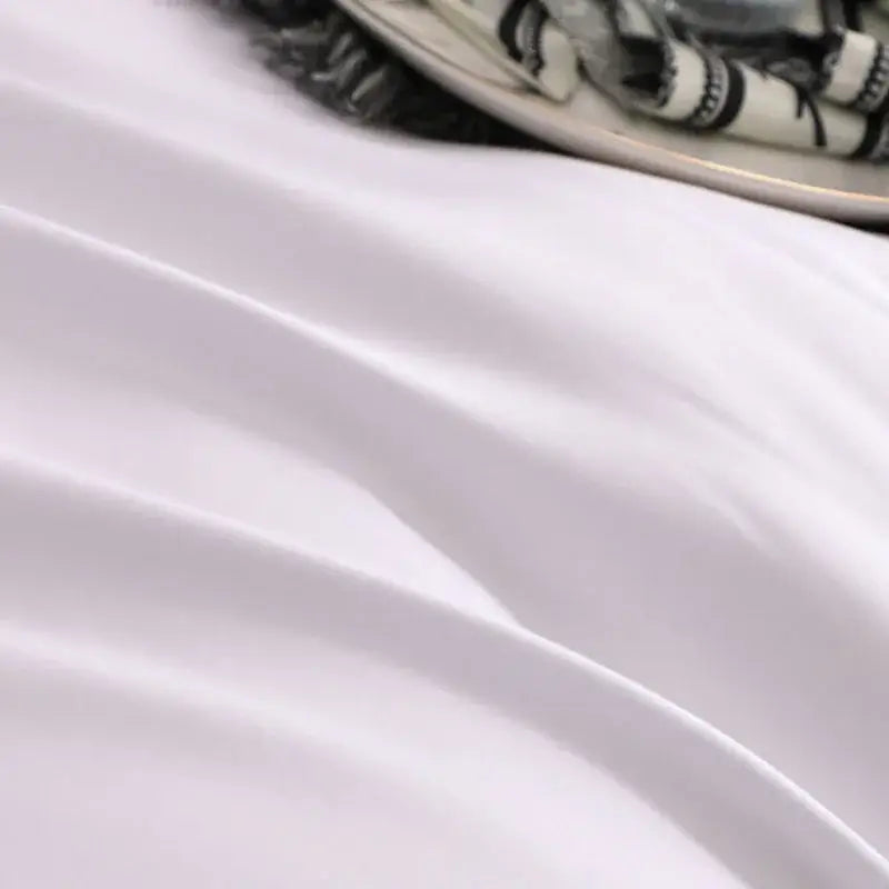 Soft white satin fabric with gentle folds and subtle sheen in decorbites brushed hotel style white gray bedding sets
