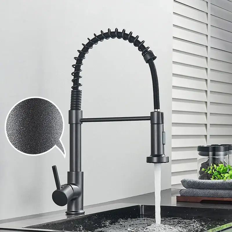 Black matte kitchen faucet with flexible coiled hose and pull-down spray head in brushed nickel decorbites style