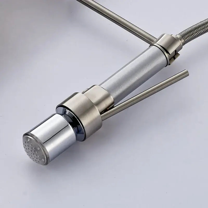 Modern brushed stainless steel faucet spray head with sleek cylindrical spout and dual hot cold handles in brushed nickel finish