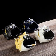 Set of four glossy ceramic ashtrays shaped as bulldogs wearing gold-trimmed sunglasses for living room decor