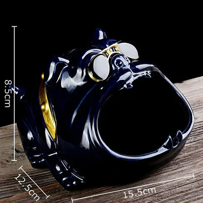 Glossy dark blue ceramic ashtray shaped like a bulldog wearing gold-rimmed goggles and a golden collar for living room decor