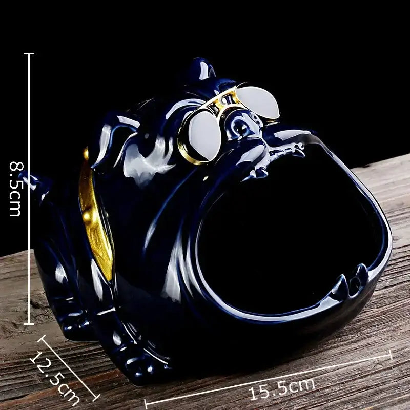 Glossy dark blue ceramic ashtray shaped like a bulldog wearing gold-rimmed goggles and a golden collar for living room decor