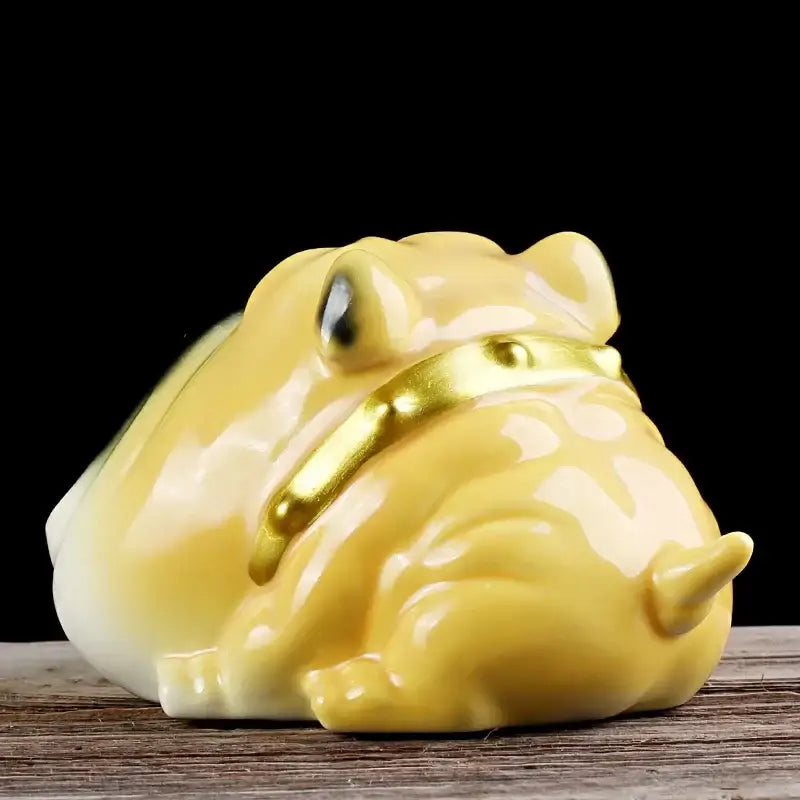 A glossy yellow ceramic frog figurine with gold collar part of bulldog sunglasses ceramic ashtray set for living room decor
