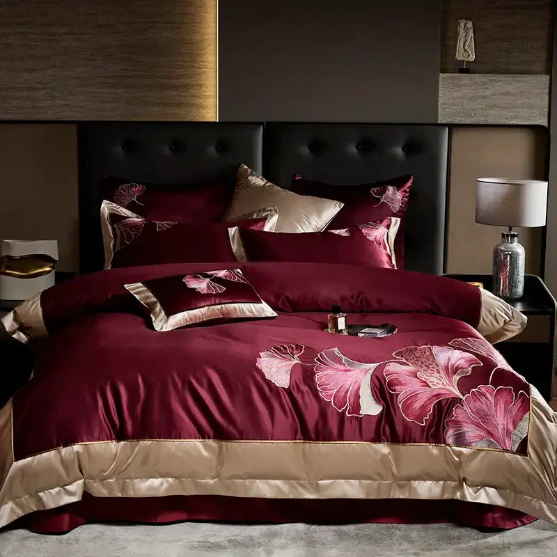 Burgundy satin comforter set with embroidered pink and white ginkgo leaf patterns and gold trim egyptian cotton decorbites ginkgo biloba bedding set