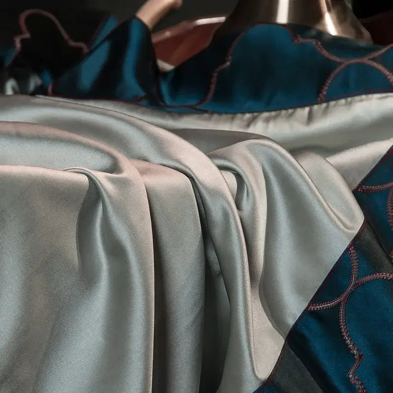 Silk satin fabric in soft silver with teal embroidered egyptian cotton embroidery details in 200s egyptian cotton bedding set