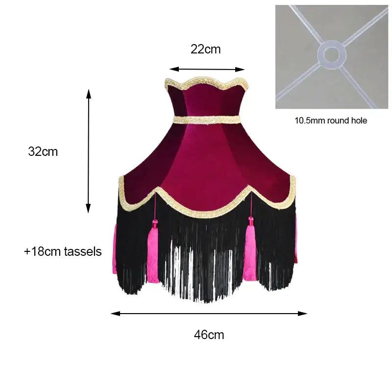 A plush burgundy wine red velvet scalloped lampshade with gold trim black fringe and vibrant pink tassels for living room