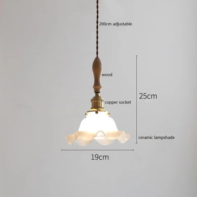 Delicate white butterfly ceramic led pendant lamp with fluted design hangs from wooden handle and copper socket on braided cord
