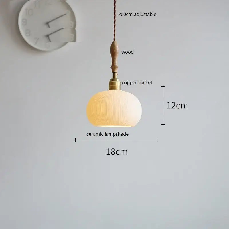 A warm-toned butterfly ceramic led pendant lamp with a textured ribbed white fluted ceramic shade and copper socket