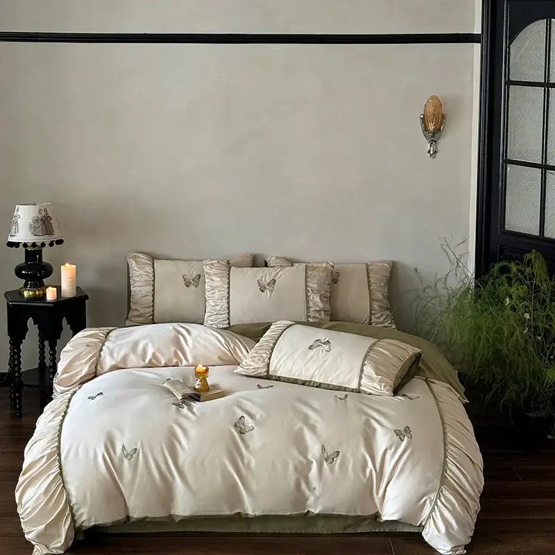 Cream satin bedding set with decorbites butterfly embroidery and ruffled edges for elegant bedroom decor