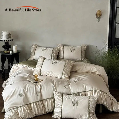 Cream satin bedding set with decorbites butterfly embroidery and ruffled edges for elegant bedroom decor