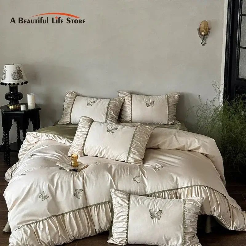 Cream satin bedding set with decorbites butterfly embroidery and ruffled edges for elegant bedroom decor