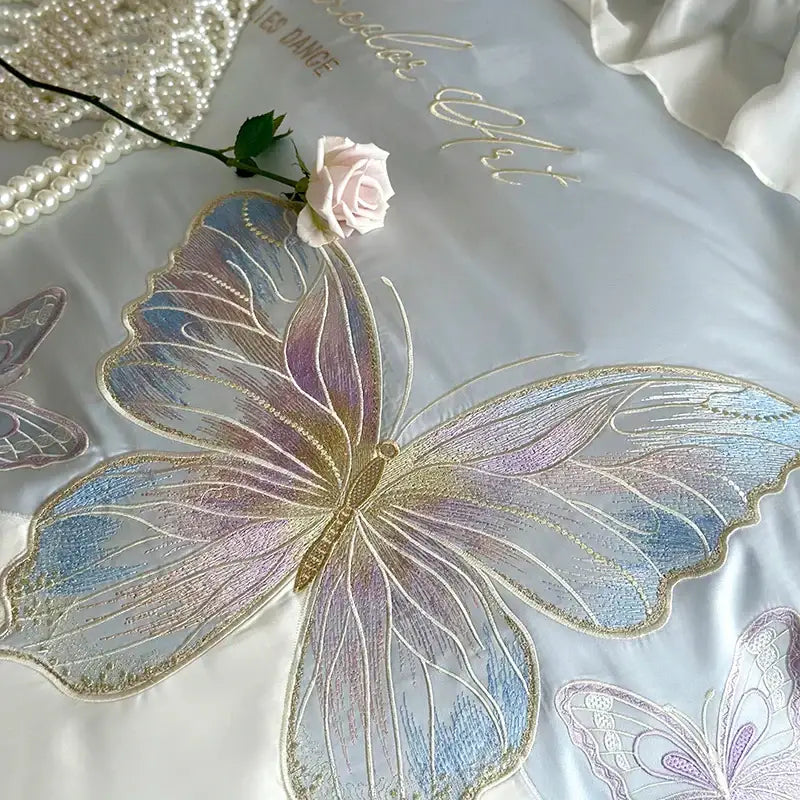 Butterfly embroidery lace ruffles bedding set in light blue cotton with iridescent blue purple and gold butterfly embroidery on white satin