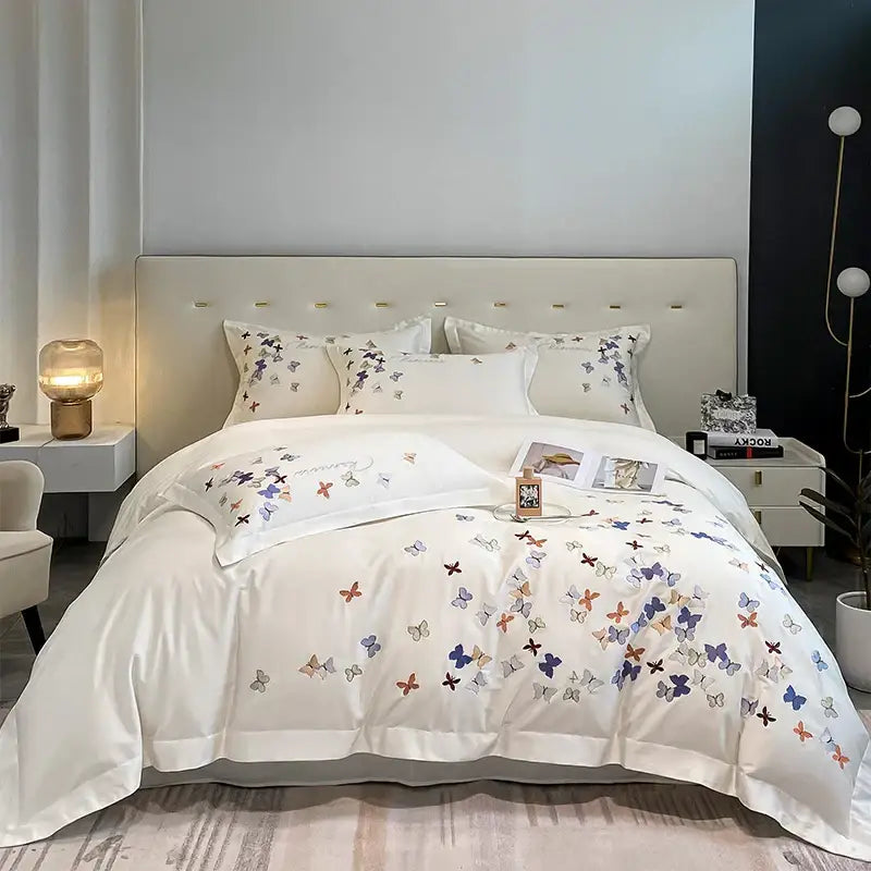 White cotton bedding set with delicate decorbites butterfly embroidery in pastel blue purple and orange for bedroom decor
