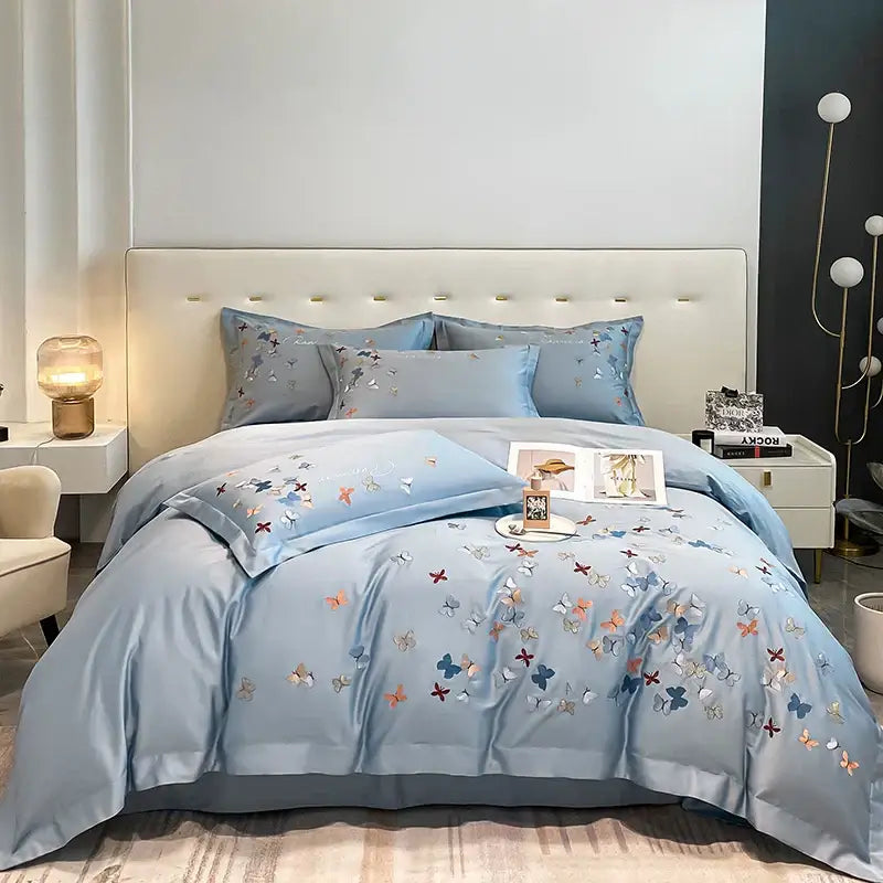 Light blue satin bedding set with decorbites butterfly embroidery in multicolored threads for bedroom decor