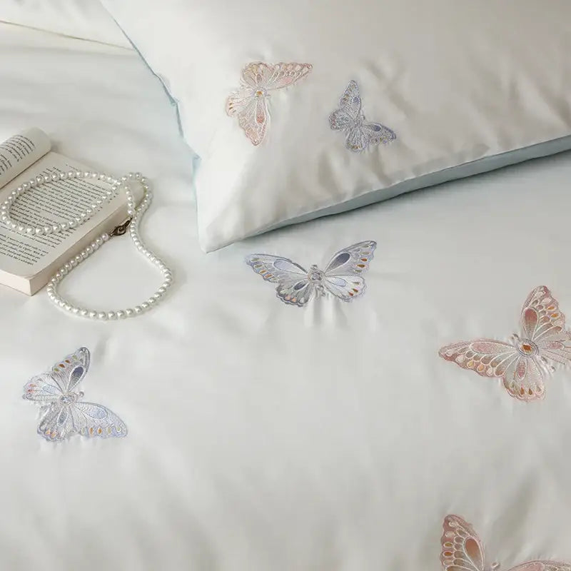 White lyocell cotton bedding set with decorbites butterfly embroidery in soft pink and silver hues for bedroom sheets
