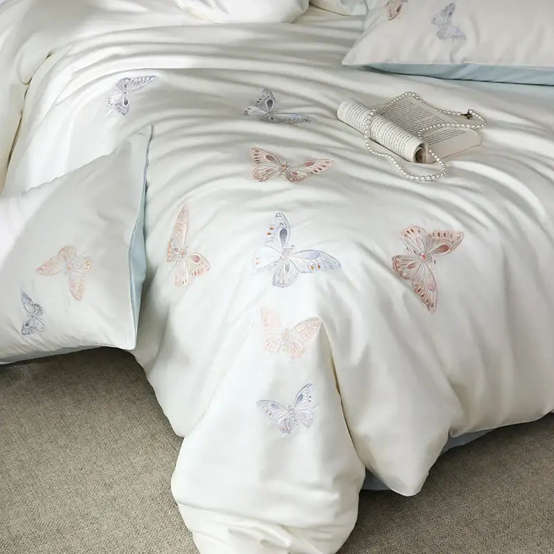 White lyocell cotton bedding set with delicate decorbites butterfly embroidery in soft pink and lavender hues