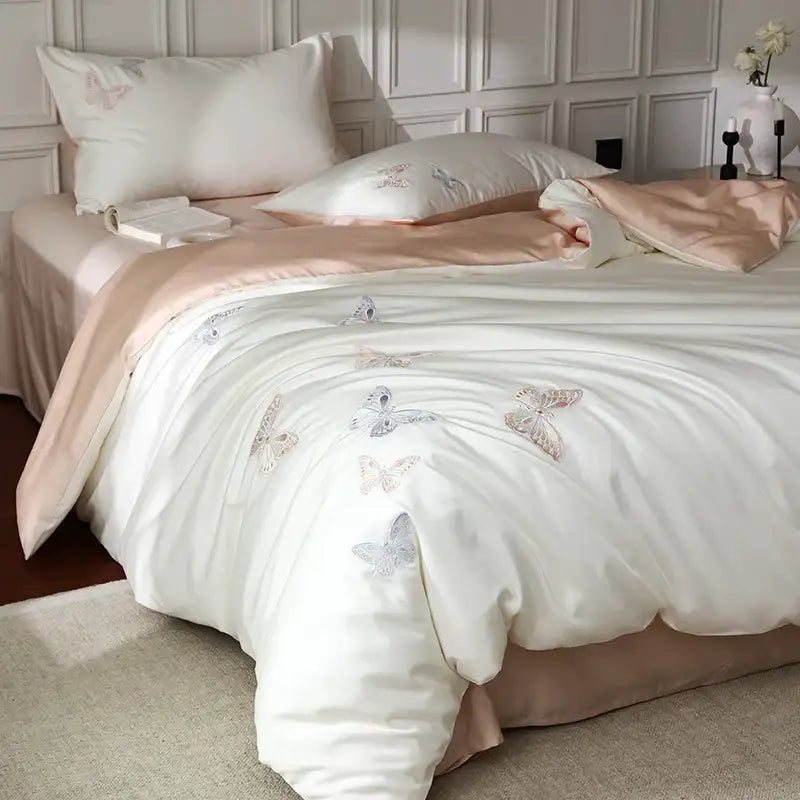 Cream-colored satin duvet cover with soft pink and silver decorbites butterfly embroidery in lyocell cotton bedding set